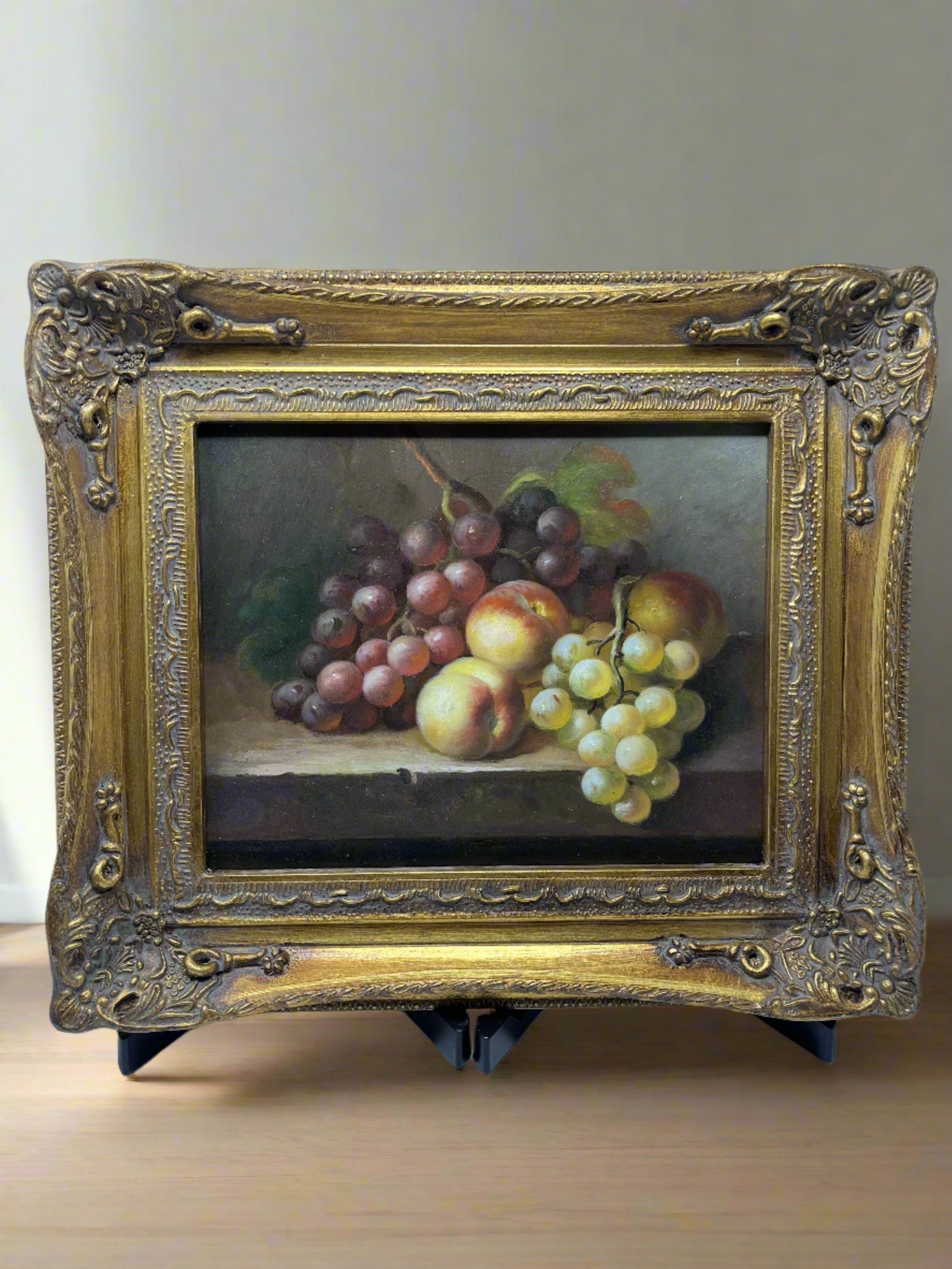 Painting of grapes and peaches on the table