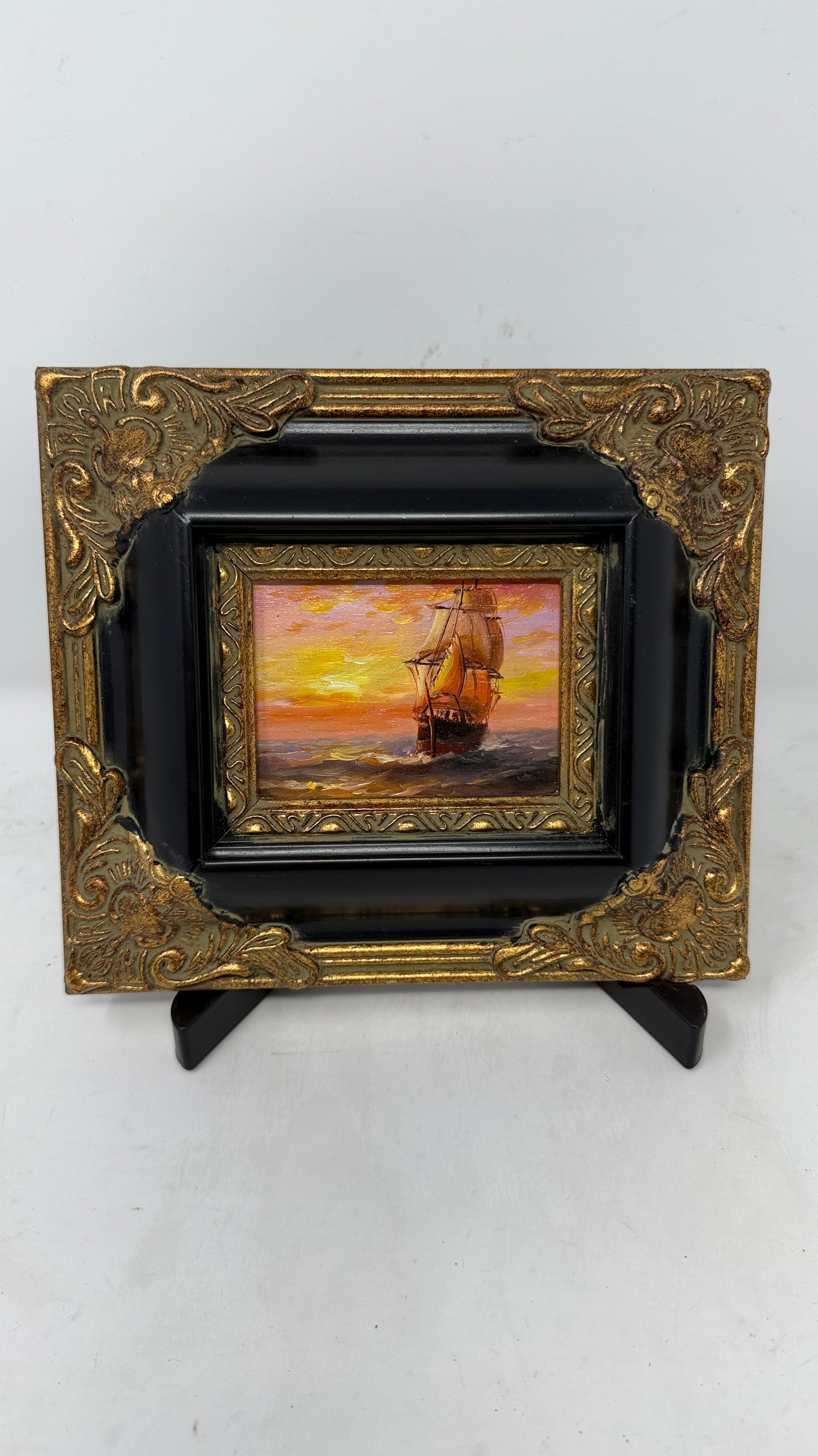 Miniature Sailing Ship at Sunset in Ornate Black & Gold Frame